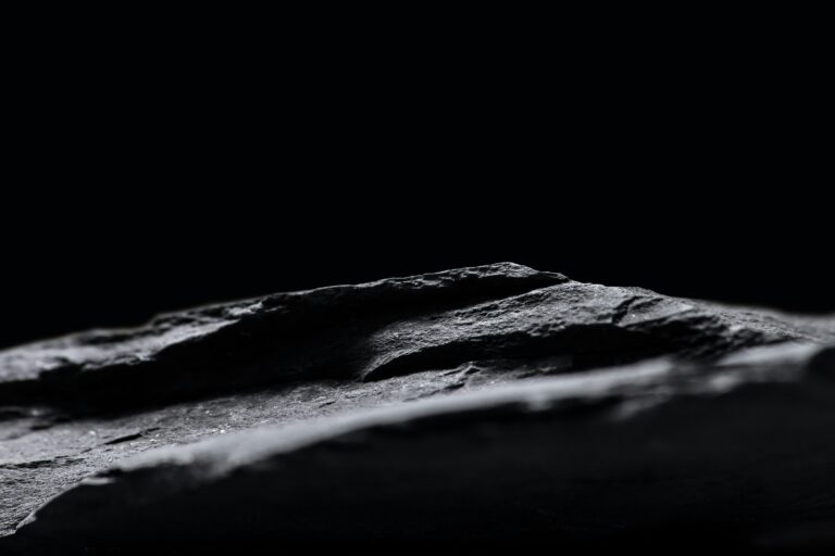 Background image containing a close-up view of a rock.